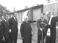 New topless cubicles in Ballam May 1970 - Lyons0016537.jpg  Cannon Kileen PP, Balla with the holy water while Fr J Cunnane CC Balla blesses the opening of the new topless cubicles in Balla. At left Mr Mc Elligott CAO Department of Agriculture Castlebar. Holding the microphone is James Walsh, Belcarra. May 1970. : 19700504 New topless cubicles in Balla 1.tif, Farmers Journal, Lyons collection