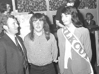 Valkenburg Hotel Sing to Success Competition - Lyons0017041.jpg  The winner of the Silk Cut " Sing to Success " competition, Valkenburg hotel, Ballinrobe, September 1974.  At left John Flannery area representative of Silk Cut cigarettes and at right Marie Devaney Silk Cut girl. : 1974 Misc, 19740909 Valkenburg Hotel Sing to Success Competition 1.tif, Ballinrobe, Lyons collection