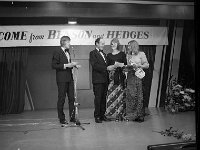Castlebar International song Contest, 1973 - Lyons0005488.jpg  Castlebar Song Contest 1973.  Gallaghers' Director ??? presenting Brigid Donoghue with her prize in the Sing to Success competition as compere Des Keogh looks on. : Castlebar Song Contest, Donoghue, Keogh