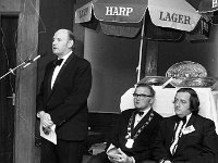 Castlebar International song Contest, 1974 - Lyons0005507.jpg  Castlebar Song Contest 1974. A director from Guinness Ireland speaking at the contest. Seated Sean Horkan President Chamber of Commerce and John Heneghan Festival Committee. : Castlebar Song Contest, Heneghan, Horkan