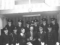Thomas Greer, Castlebar retiring from the Fire Service, June 197 - Lyons0012630.jpg  Thomas Greer with his daughter & Captain Garvey & his fellow colleagues in the Castlebar Fire Service at the retirement function, June 1970. : 1970 Misc, 19700625 Castlebar Fire Brigade Presentation in the Welcome Inn, Lyons collection