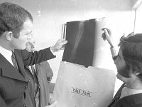 Arrival of Joe Early at Castlebar Airport, December 1971. - Lyons0012751.jpg  Arrival of Joe Early at Castlebar Airport, December 1971.  Ray Prendergast and a friend looking at Joe Early's x-ray. : 1971 Misc, 19711216 Arrival of Joe Early at Castlebar Airport 4.tif, Castlebar, Lyons collection