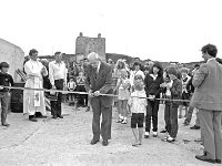 Electricity switch-on, Clare Island - Lyons0009126.jpg  Clare Island : switch on of electricity on the island. Mr Sean Mc Bride cutting the tape for the official switching on .. (Neg 17 14A)