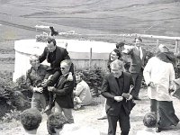 Group water scheme, Clare Island - Lyons0009139.jpg  Clare Isalnd:  Fr Denis Carney carried shoulder high by Islanders Chris O' Grady and Charles O' Malley to the amusement of Fr Michael Molloy Secretary of Archbishop Cunnane after the opening of the water scheme. (Neg 8A)