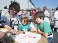 Clare Island school centenary. - Lyons0009169.jpg  Clare Island school centenary. Mary Mc cabe cutting up the centenary cake while some of her pupils look on longingly. (Neg 24 25)