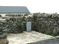 The grave of an English pilot who crashed on Clare Island in World War two. - Lyons0009254.jpg  The grave of an English pilot who crashed on Clare Island in World War two.  The grave had been outside the consecrated grounds because he was non-catholic but Fr Ned Crosbie took away the boundary wall and incorporared the grave into the Church yard.