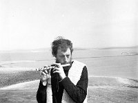 Sid Rawle playing a tune on his hand-made flute on Dorinish Island., August 1971 - Lyons0020492.jpg  Sid Rawle playing a tune on his hand-made flute on Dorinish Island., August 1971