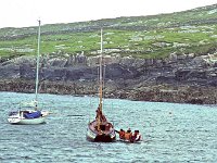 Inishturk: Liam Lyon's yacht on anchor - Lyons0008891.jpg  Inishturk: Liam Lyon's yacht on anchor and a crew boarding their hooker, a traditional sailing boat. (Neg 2A 3) : 198706 Inish Turk 3.tif, Inish Turk, Lyons collection