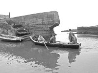 Inishturk harbour - Lyons0008925.jpg  Inishturk: Kevin Heanue and Michael O' Toole negotiating the badly damaged pier while they bring a mother and child in from a fishing boat. (Neg 8 7A) : 19811129 Inish Turk 14.tif, Inish Turk, Lyons collection