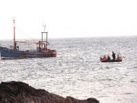 Inishturk: Doctor Mc Loughlin being brought to the fishing traw  Inishturk: Doctor Mc Loughlin being brought to the fishing trawler - Lyons0008982.jpg  Inishturk: Doctor Mc Loughlin being brought to the fishing trawler which will bring him back to the mainland. (Neg 5) : 199210 Inish Turk 34.tif, 19921001 Inish Turk 34.tif, Inish Turk, Lyons collection