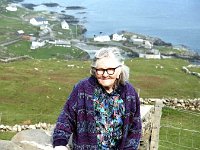 Inishturk: Mrs O' Toole infront of her house - Lyons0008987.jpg  Inishturk: Mrs O' Toole infront of her house and the harbour in the background. (Neg 23A 24) : 199210 Inish Turk 40.tif, 19921001 Inish Turk 40.tif, Inish Turk, Lyons collection