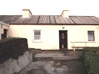 Inishturk: Tess standing in the Post Office doorway - Lyons0009012.jpg  Inishturk: Tess standing in the Post Office doorway. (Neg 1A 2) : 19921001 Inish Turk 70.tif, Inish Turk, Lyons collection