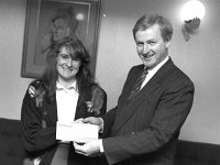 Dympna Murray from Skirdagh, Newport presenting a cheque to Enda Kenny TD, 1990. - Lyons0016504.jpg  Dympna Murray from Skirdagh, Newport presenting a cheque to Enda Kenny TD for the Mater Hospital Heart Transplant Club fund. She raised the money locally before she competed in the Dublin city marathon.The portrait in the background is of the most famous Castlebar lady soprano Margaret Bourke Sheridan. november 1990. : 19901125 Dympna Murray presenting cheque.tif, Lyons collection, Newport