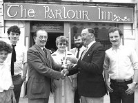 Parlour Inn sale, Westport, June 1984 - Lyons0019760 1.jpg  Centre Vera Rosenkratz and her husband Edward Rosenkratz handing over the keys of the Parlour Inn, Bridge St to Mickey Cavanagh the new owner. Westport, June 1984 : 19840625 The Parlour Inn.tif, Lyons collection, Westport Developing