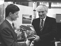 Westport Tourism Press Conference , March 1988. - Lyons0019768 1.jpg  Westport Tourism Press Conference and Brochure Launching by Mr John Wilson Minister for Tourism in Bank of Ireland. Michael O' Donnell, Chairman of westport Tourism Marketing Committee making a presentation of Carraig Donn knitwear Westport product to Minister for Tourism John Wilson. March 1988 : 19880329 Westport Tourism Press Conference 4.tif, Lyons collection, Westport Developing