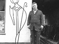 Tom Hoare blacksmith from Westport, 1962. - Lyons0013834.jpg  Tom Hoare blacksmith from Westport with his wrought iron figure os St Patrick. His workshop was at the back of the pub they owned on James St. 1962. : 1962 Tom Hoare blacksmith.tif, Lyons collection, Westport