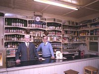 Dan Mc Ging's Grocery Shop and Bar, Bridge Street, Westport, 1983 - Lyons0014119.jpg  Dan Mc Ging's Grocery Shop and Bar, Bridge Street, Westport,  also farm suppies. Dan Mc Ging and his son Michael at the counter., May 1983. Now Matt Molloy's pub. : 198305 Dan & Michael Mc Ging.tif, Lyons collection, Westport