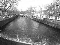 The Carrowbeg river flowing through the centre of the Mall, Westport, November 1971. - Lyons0014709.jpg  The Carrowbeg river flowing through the centre of the Mall, Westport, November 1971. : 19711123 Westport 11.tif, Farmers Journal, Lyons collection, Westport, Westport.