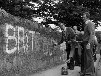 Graffitti in Westport, July 1978.. - Lyons0015036.jpg  Cllr M Cavanagh in action painting out the graffitti. Graffitti in Westport, July 1978 : 1978 Misc, 19780727 Graffitti in Westport 2.tif, Lyons collection, Westport