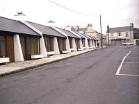 Plougestal Court Westport, October 1979. - Lyons0015105.jpg  Town Council development on Plougastal Court for elderly people living alone. Note at the top of the Street the old Westport House Estate office which was run by Ms Henrietta Moore and is now the site of the Castlecourt Hotel. October 1979. : 1979 Misc, 19791010 Plougastal Court Westport 1.tif, Lyons collection, Westport