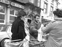Street traders in Westport, December 1986. - Lyons0015374.jpg  Street trading on Main St, Swinford. Foreground twins Clare and Clodagh Caulfield. December 1986. : 19861203 Street traders 2.tif, 19861203 Street traders 3.tif, Farmers Journal, Lyons collection, Westport