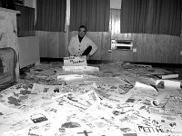 Paddy Hopkins Chairman Third World Committee 1988. - Lyons0015491.jpg  Paddy Hopkins Chairman Third World Committee showing the huge variety of posters for the competition, March 1988. : 19880324 Posters for competition 2.tif, Lyons collection, Westport