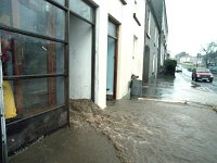 Flooding on the Mall, Westport, February 1990. - Lyons0015598.jpg  Flooding on the Mall, Westport, February 1990.  Water coming out of the hall door of King's solicitors. : 19900204 Flooding on Westport Mall 5.tif, Lyons collection, Westport