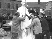 Placing the statue of St. Patrick on top of the pedestal on the Octagon, March 1990 - Lyons0015618.jpg  Placing the statue of St. Patrick on top of the pedestal on the Octagon, March 1990. John Coffey and Ken Thompson sculptor. : 19900307 Placing of the Statue of St Patrick 1.tif, Lyons collection, Westport