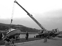 Dr Peter Gill's boat being lifted out of the water by Liam Moran at Westport Quay, October 1993. - Lyons0015873.jpg  Dr Peter Gill's boat being lifted out of the water by Liam Moran at Westport Quay, October 1993. : 19931027 Westport Harbour.tif, Lyons collection, Westport