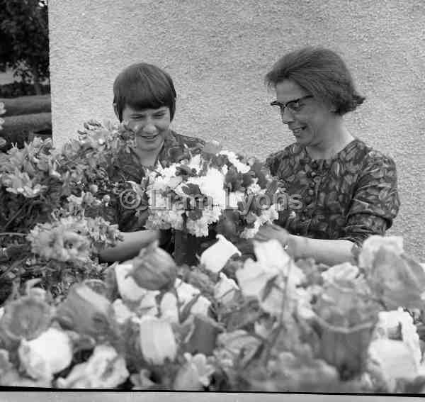 Mrs Gibsey right tending her flowers