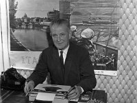TP Brennan in his new Travel Agency, 1965. - Lyons0000408.jpg  TP Brennan in his new Travel Agency, 1965. T P Brennan was also member of Westport Post Office Staff & one of the people who was instrumental in starting the Westport Sea-angling, Westport soccer/football pitch & the road to Bertra. He was a member of many other local voluntary organisations. : Brennan, collection, new, Travel