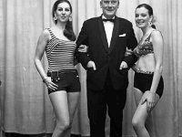 Irwin's Fashion Show in the Travellers Friend Hotel - Lyons0001103.jpg  Irwin's Fashion Show in the Travellers Friend Hotel. Paddy Irwin with two of the models. Original folder, 1968 Misc : Fashion show, Paddy Irwin, Traveller's Friend Hotel