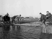 Flooding of bridge in Garrymore. - Lyons0001270.jpg  Flooding of bridge in Garrymore.Helping children to cross the river so they can get to school. : Flooding, Garrymore