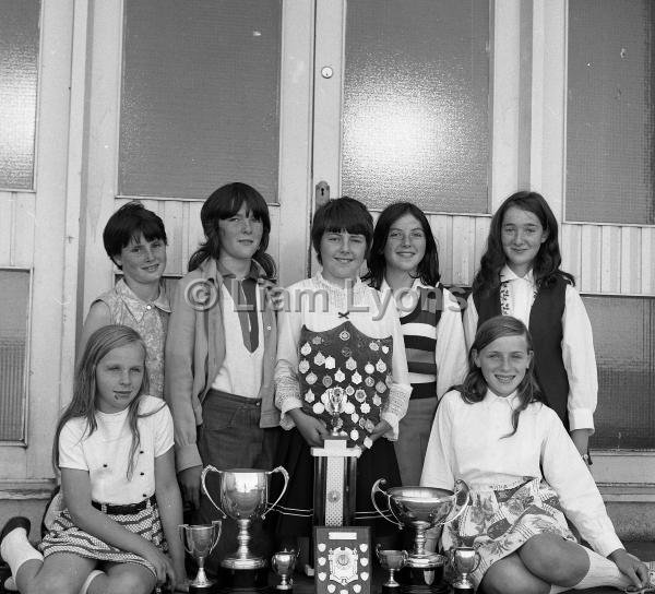 Kilmaine girls for Mrs Quinn with their cups and medals