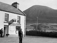 Ms Peggie Staunton's pub in Lecanvey - Lyons0002935.jpg  Peggie Staunton standing outside her pub with Croagh Patrick in the background for Gerturd Horgan, Thomas Aquinas College, Louisburgh. : Lecanvey, Staunton