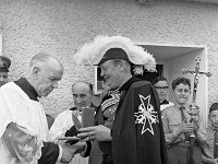 Order of Malta, celebrations in Westport, 1969. - Lyons00-20979.jpg  Count Noel Peart KM making a presentation to Cannon Tom Cummins ADM, Westport. Also in the photo Fr Eamon O' Malley CC Westport, Fr Dominic Grealy CC Westport and the cross bearer is Ger Burns who later became a priest of the Tuam diocese. : 19690531 Celebrations in Westport 1.tif, Lyons collection, Order of Malta