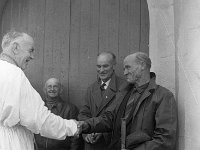 Pilgrimage Day on Croagh Patrick, 1972. - Lyons00-21022.jpg  Cannon Tom Cummins Westport meets an old friend. Standing with his back to the door of the church is Cllr Mickey Kelly, Westport and Austin Gannon, Murrisk both of these men dedicated their lives to Croagh Patrick to helping the smooth running of the pilgrimage and both got papal honours for their dedication to Croagh Patrick. : 197207 Pilgrimage Day on Croagh Patrick 28.tif, Lyons collection, Order of Malta