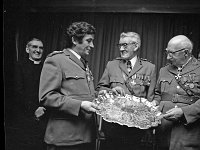Order of Malta, 1975. - Lyons00-21034.jpg  Presentation to Captain William Lyons DM former Officer in charge of Westport's Order of Malta. Centre Captain William Lyons receiving a silver chain from Dr Bert Farrel Medical Officer with the Order and at right Dr. McHugh from the Galay unit. Seen at left back the Rev Mr Mc Giley, Holy Trinity Church Westport. : 19750110 Presentation to Commandant William Lyons 1.tif, Lyons collection, Order of Malta